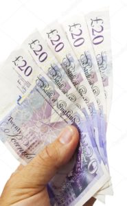 Image shows hand holding £100 in sterling, cash. Could Covid-19 Stay-Safers do what Chancellors haven't been able to, and pave the way to a Cashless Society?