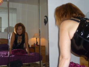 Fun50Minx mature female escort in the North East by a mirror