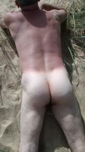 Naked male sunbathing