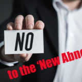 Man holding 'No' sign to the new Abnormal'